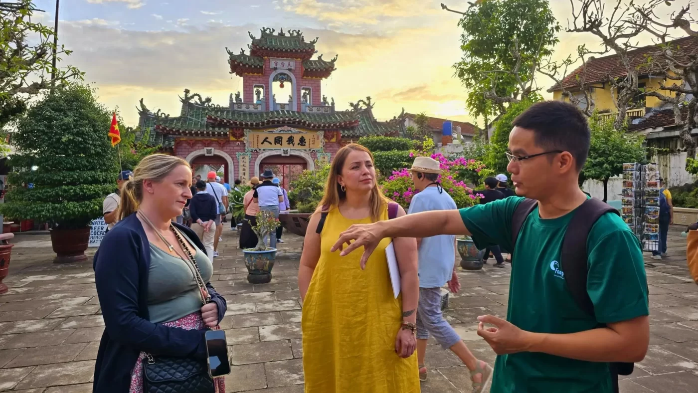 Travellers walking with a local guide through a village in Vietnam
