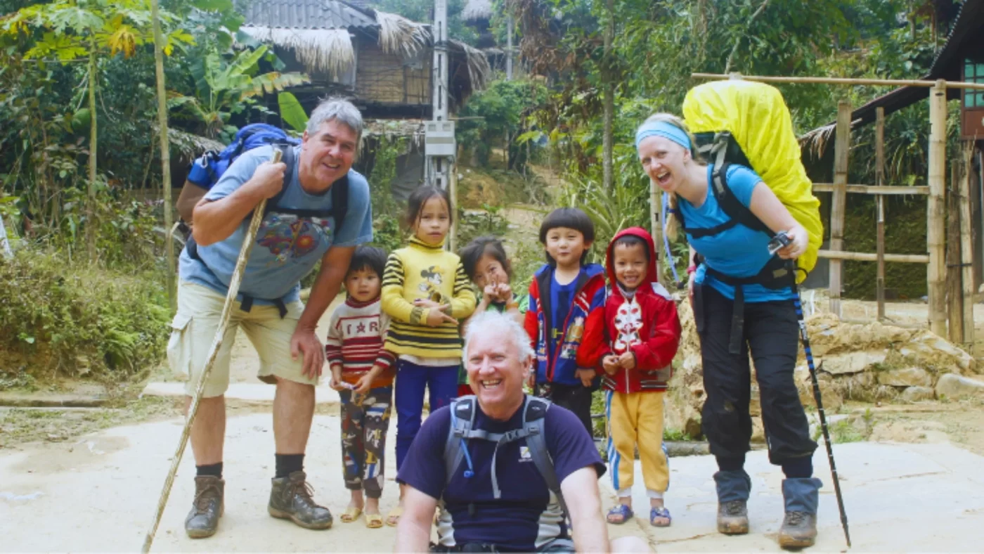 Travellers talking with local children on a path in the Pu Luong valley